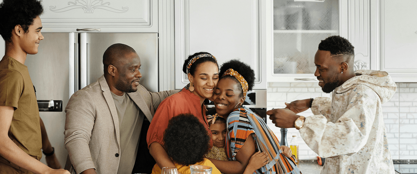 A family embracing warmly in their kitchen